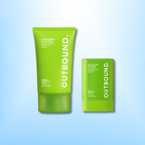 Two green bottles of 'Outbound' sunscreen on a light blue background
