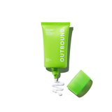 Green tube of Outbound sunscreen with white cream on a white background