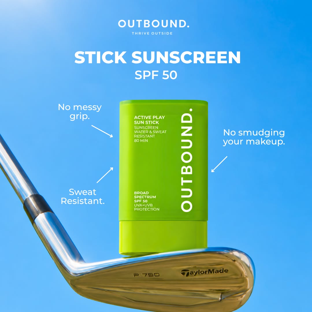 A bright lime green OUTBOUND Stick Sunscreen SPF 50 container is centered against a bright blue sky background, with a golf club head at the bottom left. White text highlights product features: 'No messy grip,' 'Sweat Resistant,' and 'No smudging your makeup.