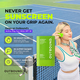 A woman on a tennis court holds an OUTBOUND Active Play Sun Stick SPF 50 sunscreen stick. The ad features bold text promoting the product and lists key benefits like no greasy palms and no slippery racquet.